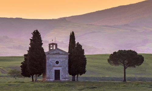 Chapel of Madonna in morning light in the hills of Tuscany, Italy, April.